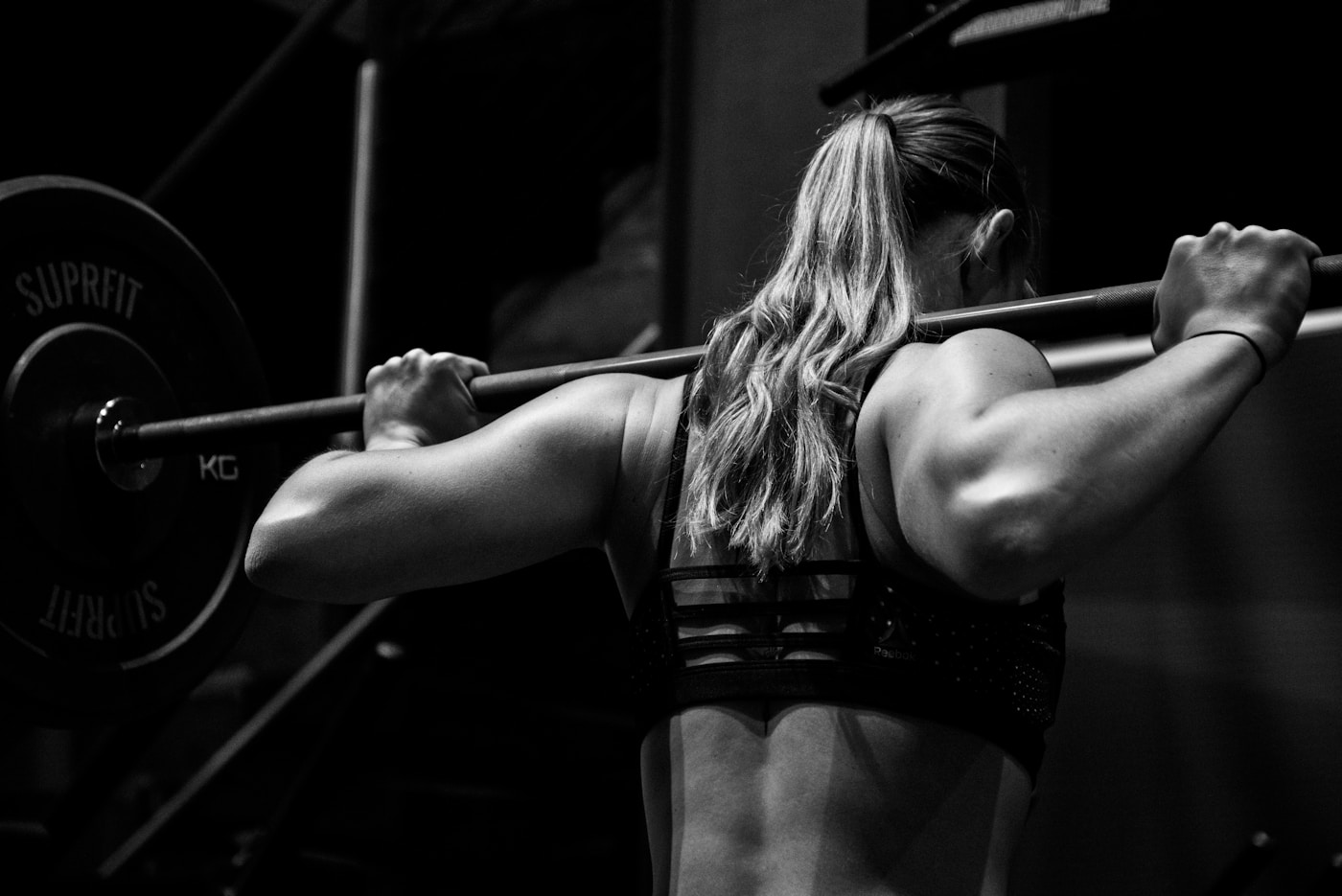 Personal coach guiding a client through strength training